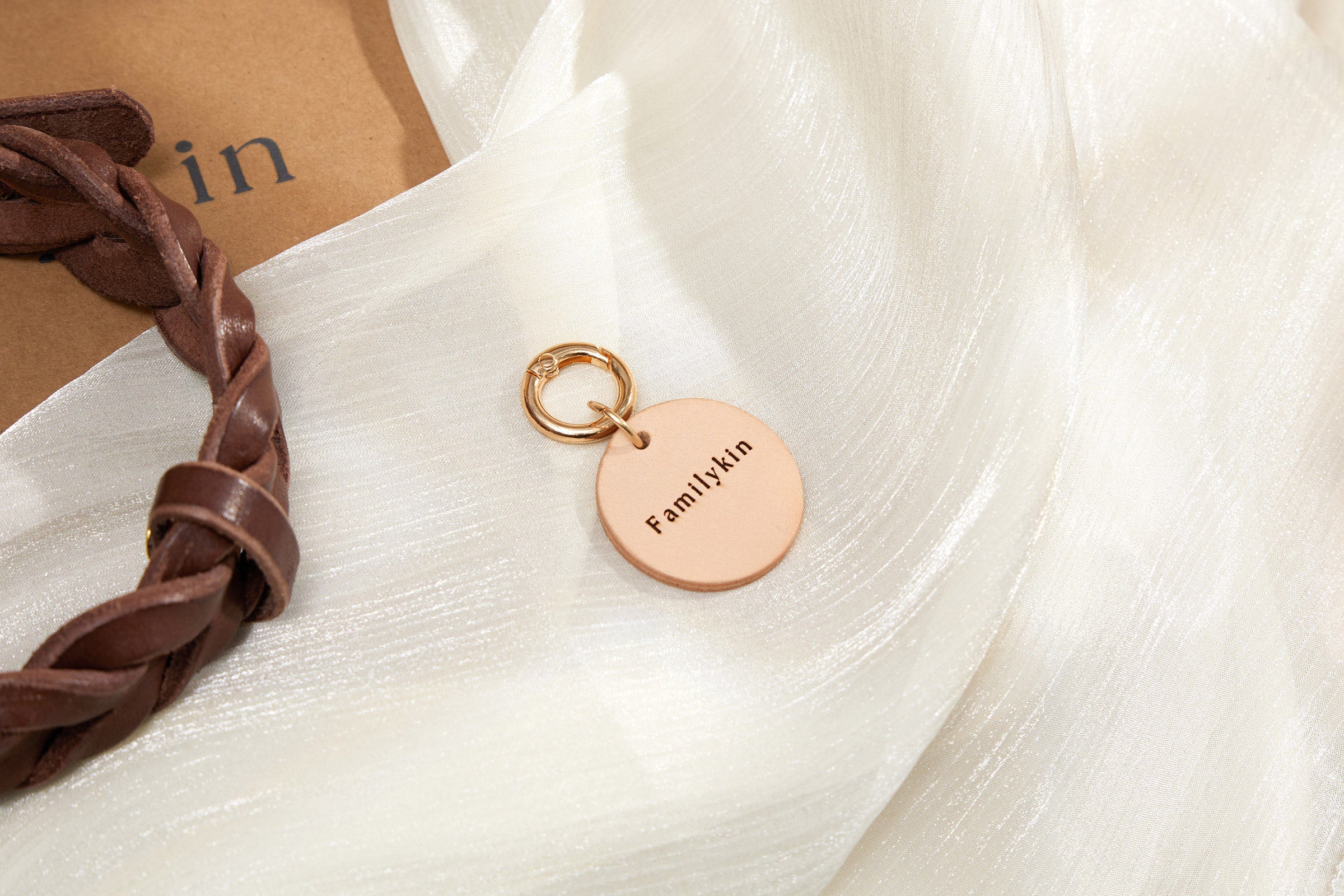 Personalized leather dog tag shown with name detail and natural leather texture.