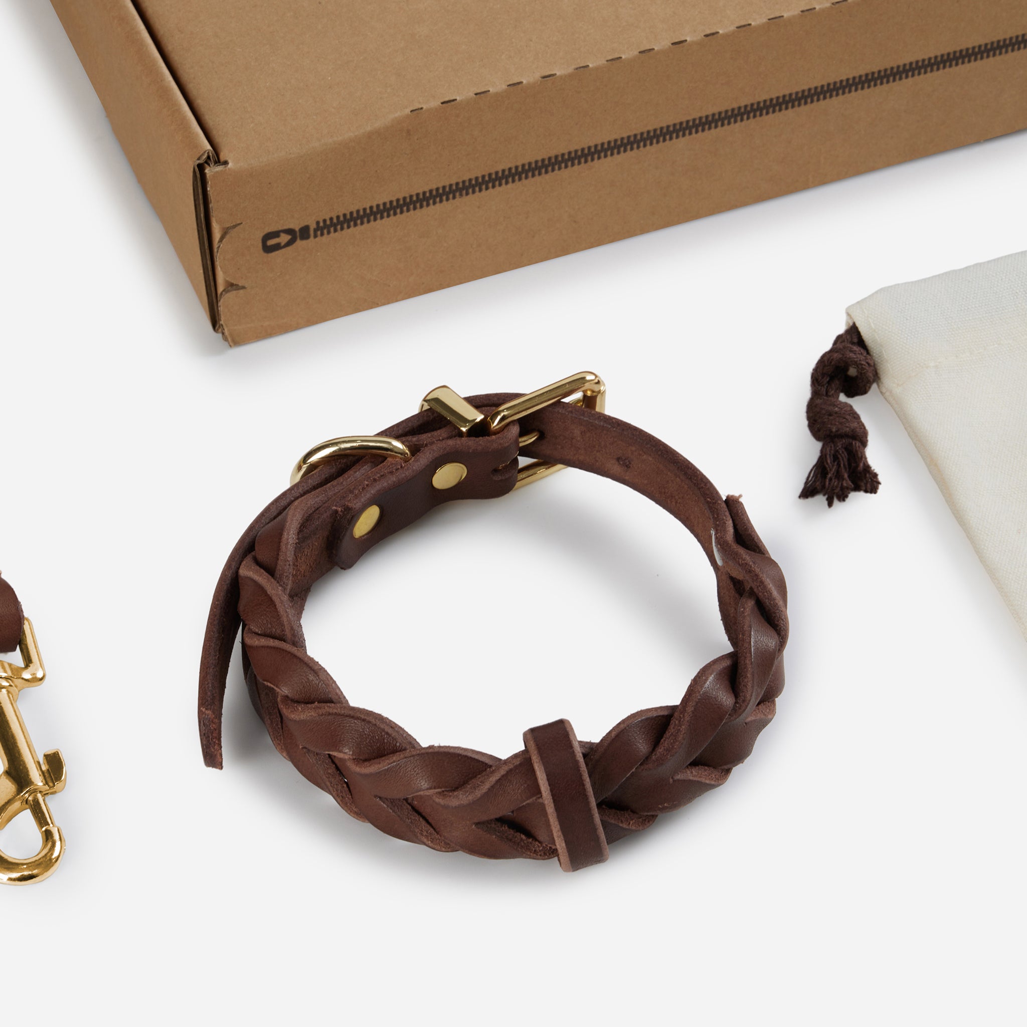 Everyday Walk Set with braided leather collar, walk leash, waste bag dispenser, and refill rolls.